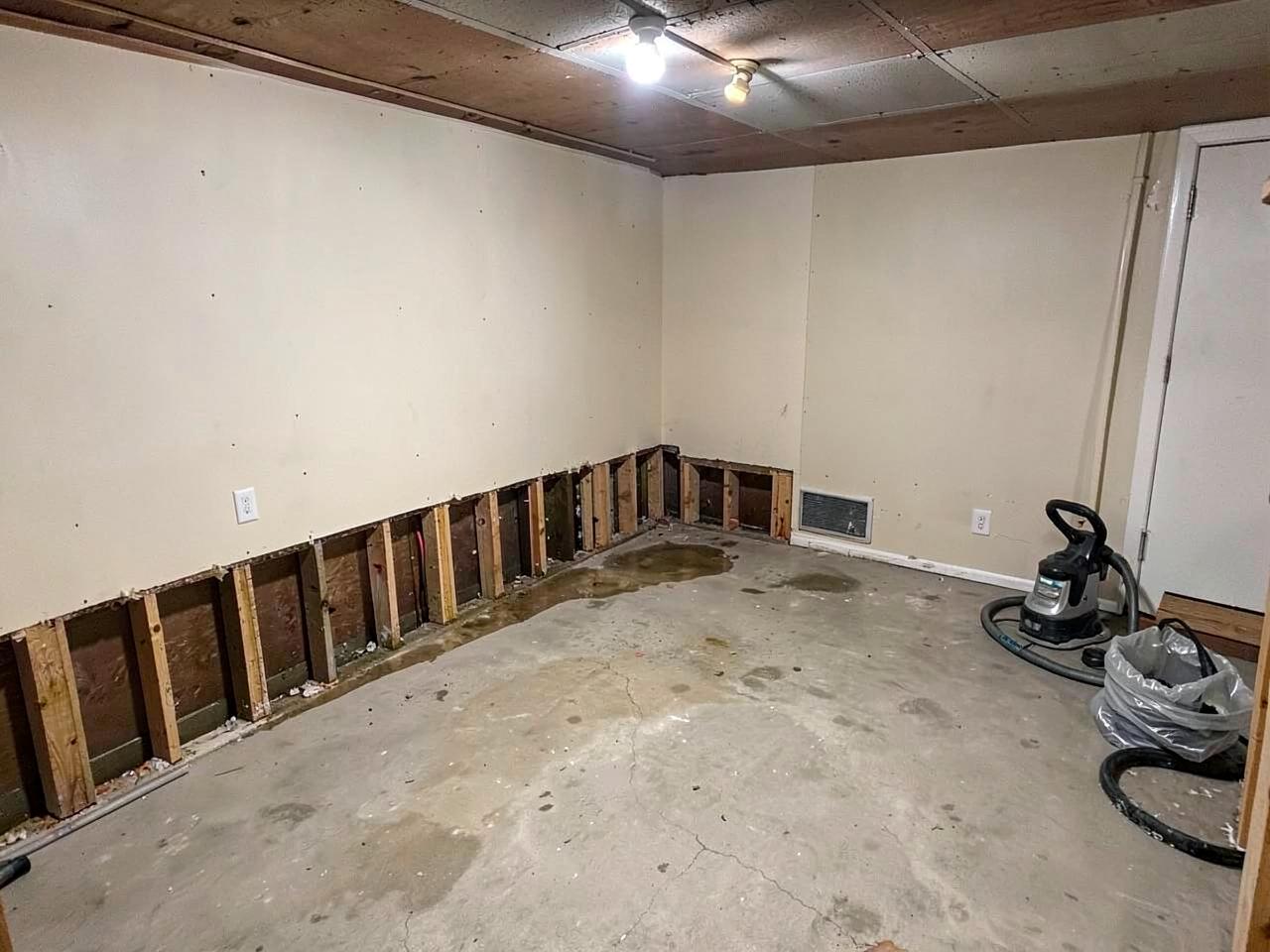 Mississauga basement with lower drywall removed and floor drying after a flood